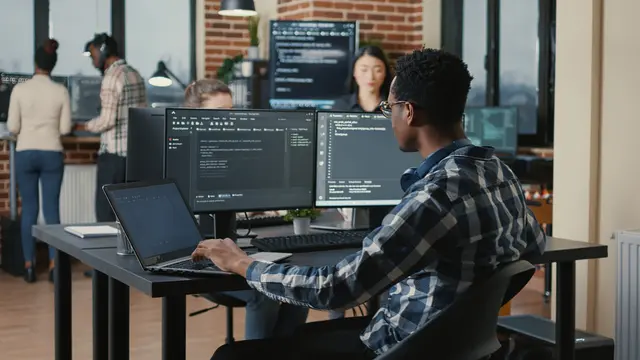 Software engineers working across multiple code screens